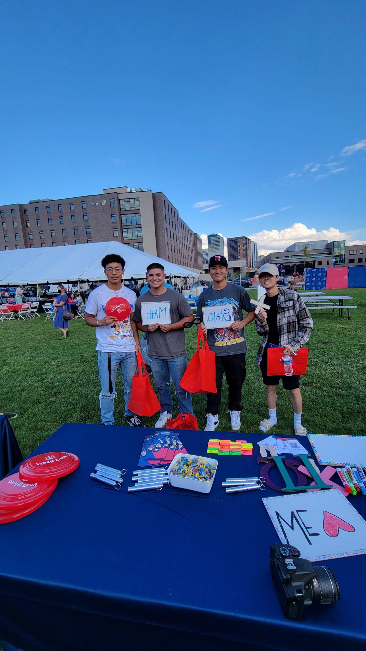 Math and Stats students having fun at an outdoor event holding